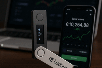 A photograph showcases a Ledger Nano X cryptocurrency hardware wallet placed on a wooden surface, surrounded by coins and a smartphone, highlighting secure digital asset storage.